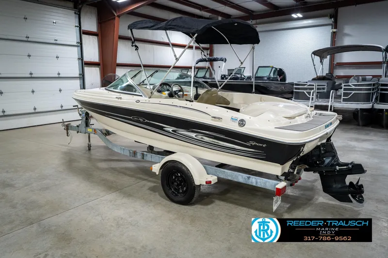 Slide: The Image of 2005 Sea Ray 180 Sport boat in a garage, rear view with trailer. - 10