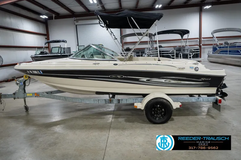 Slide: The Image of 2005 Sea Ray 180 Sport boat on trailer in indoor showroom. - 11