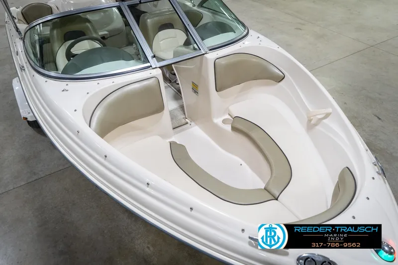 Slide: The Image of 2005 Sea Ray 180 Sport boat interior with beige seating and windshield. - 13