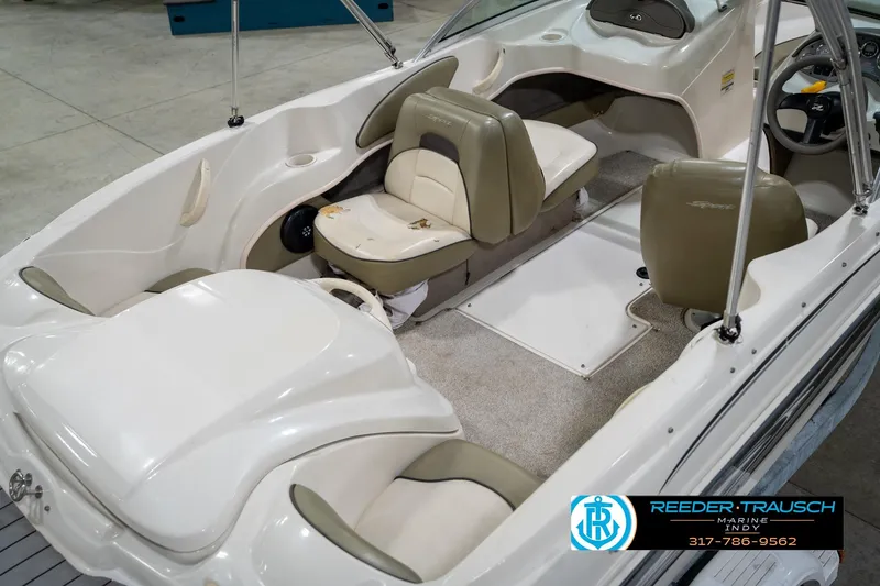 Slide: The Image of 2005 Sea Ray 180 Sport boat interior with beige seating and steering wheel. - 14