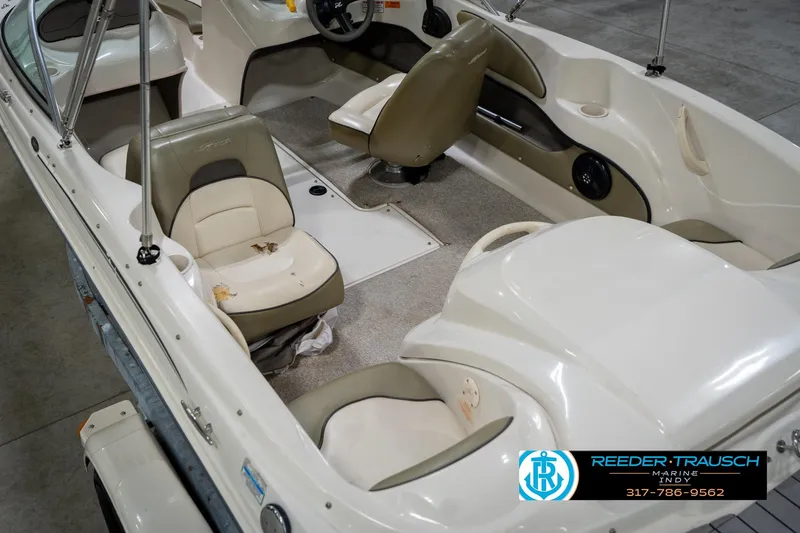 Slide: The Image of 2005 Sea Ray 180 Sport boat interior with beige seating and steering wheel. - 15