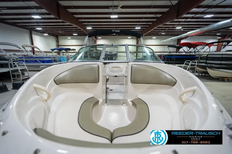 Slide: The Image of 2005 Sea Ray 180 Sport boat interior with beige seating and steering wheel. - 16