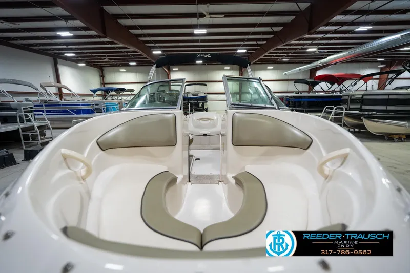 Slide: The Image of 2005 Sea Ray 180 Sport boat interior in a showroom, featuring seating and steering wheel. - 17