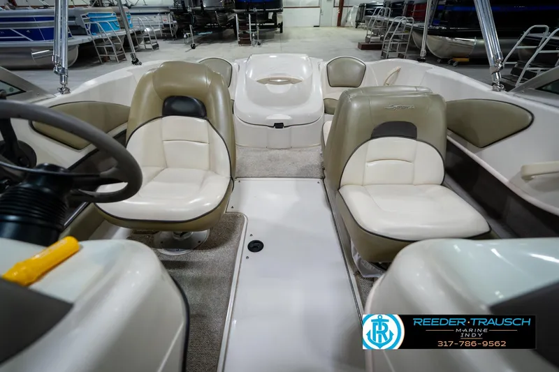 Slide: The Image of 2005 Sea Ray 180 Sport boat interior with steering wheel and dashboard in a showroom. - 18