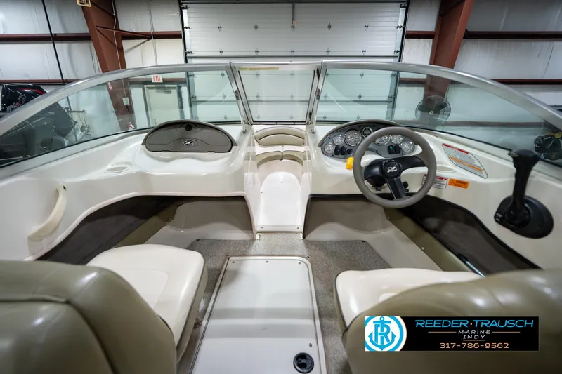 Slide: The Image of Interior of 2005 Sea Ray 180 Sport boat with beige and white seating. - 21