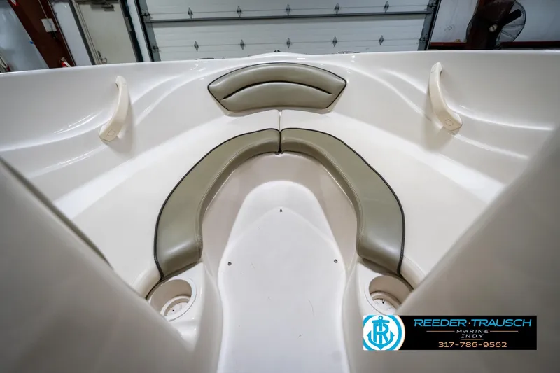 Slide: The Image of Interior of 2005 Sea Ray 180 Sport boat with beige seating and carpeted floor. - 22
