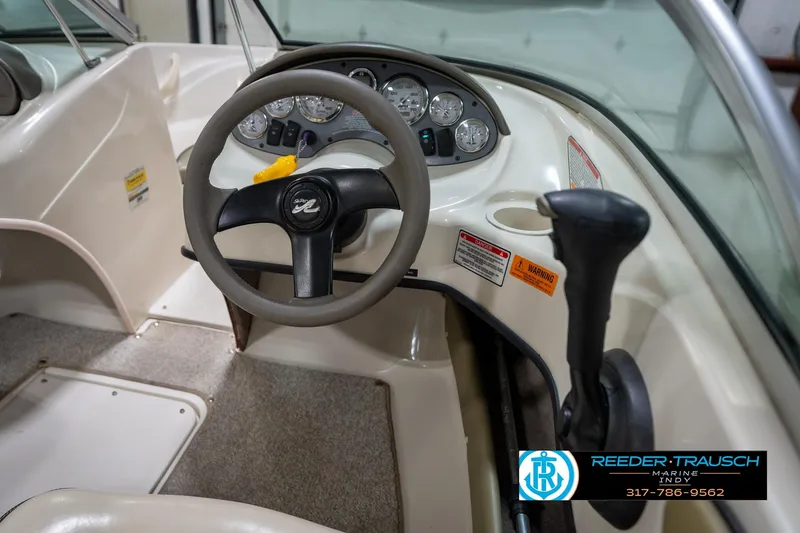Slide: The Image of 2005 Sea Ray 180 Sport boat dashboard with stereo system in a showroom. - 26