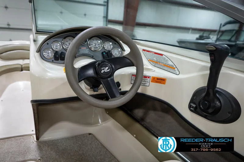 Slide: The Image of Interior view of 2005 Sea Ray 180 Sport boat, featuring steering wheel and dashboard controls. - 27