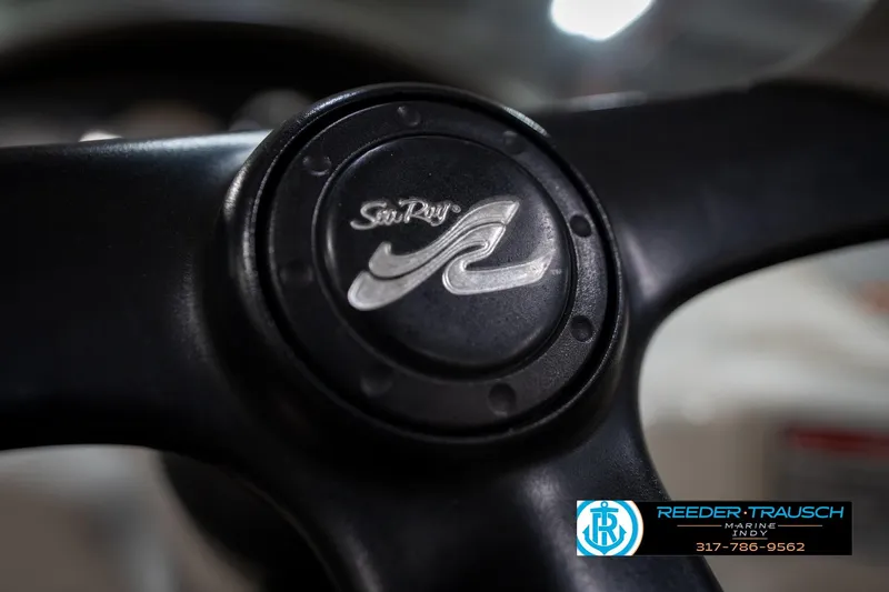 Slide: The Image of 2005 Sea Ray 180 Sport boat interior with steering wheel and control panel. - 28