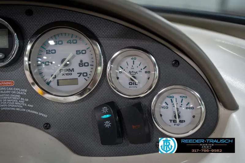 Slide: The Image of Dashboard of a 2005 Sea Ray 180 Sport boat with fuel and speed gauges. - 30