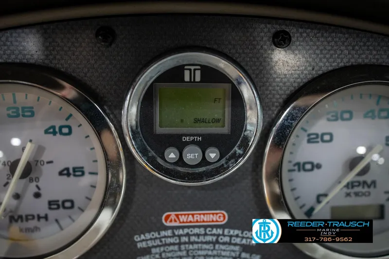 Slide: The Image of Dashboard of a 2005 Sea Ray 180 Sport boat with RPM, oil, and temperature gauges. - 32