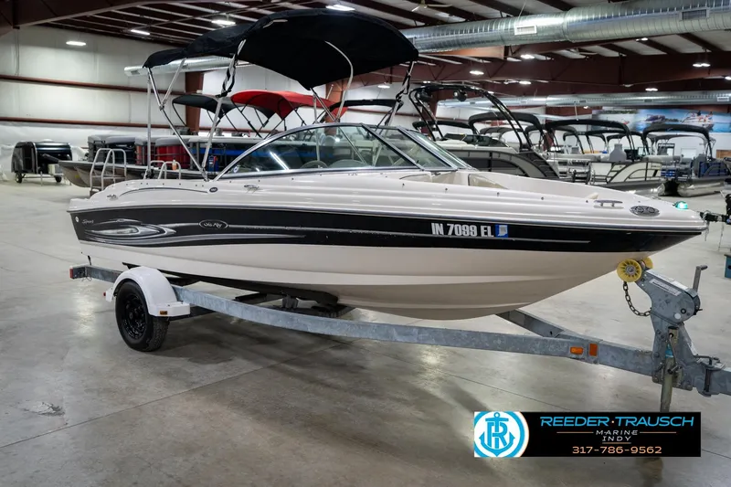 Slide: The Image of 2005 Sea Ray 180 Sport boat in showroom, front view, with canopy and trailer. - 6