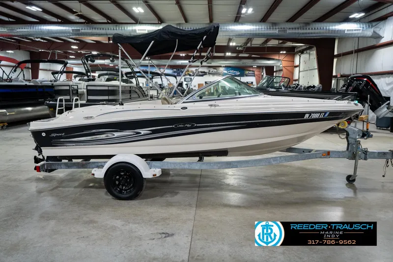 Slide: The Image of 2005 Sea Ray 180 Sport boat on trailer in indoor showroom. - 7