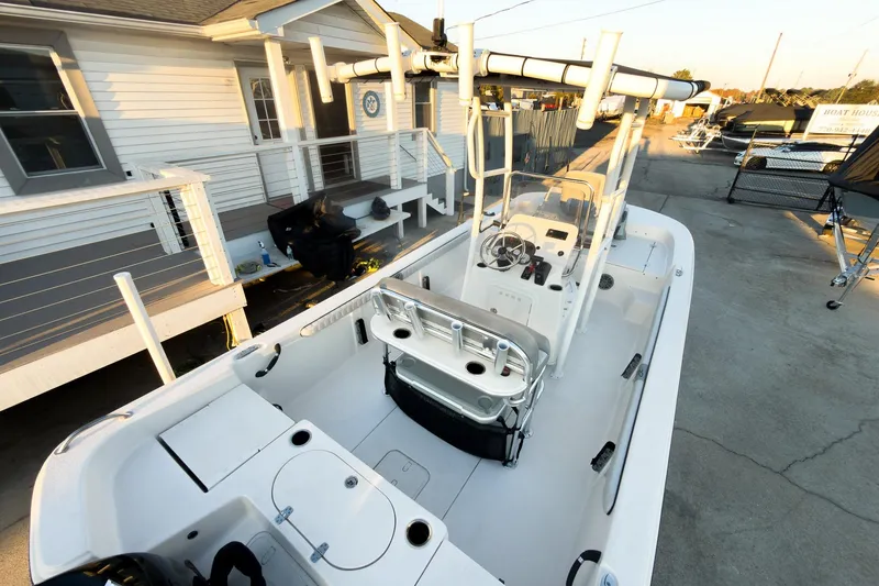 Slide: The Image of 2026 Carolina Skiff 19 LS boat docked near a house, showcasing spacious interior design. - 15