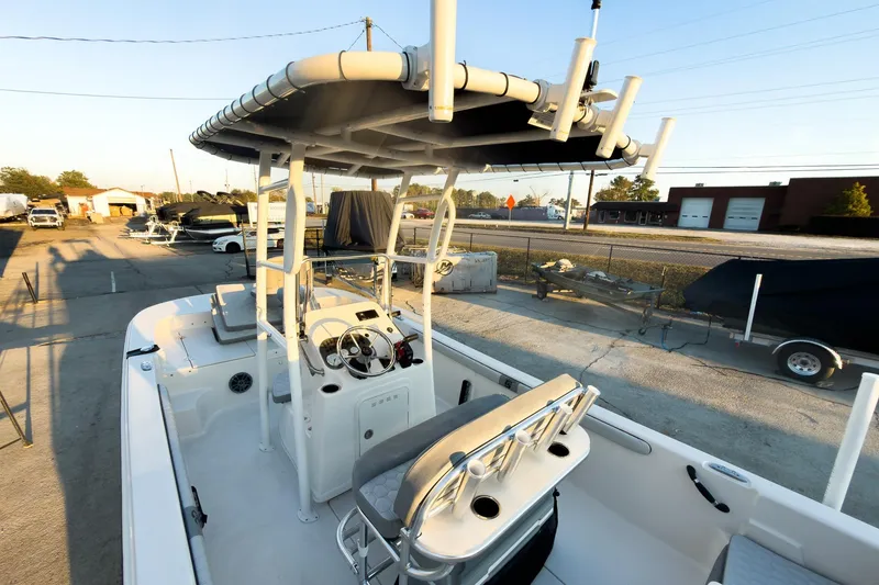 Slide: The Image of 2026 Carolina Skiff 19 LS boat with T-top and console, parked outdoors. - 16