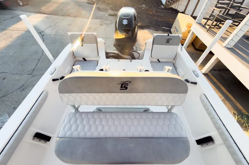 Slide: The Image of 2026 Carolina Skiff 19 LS boat interior with seating and motor, in sunlight. - 22