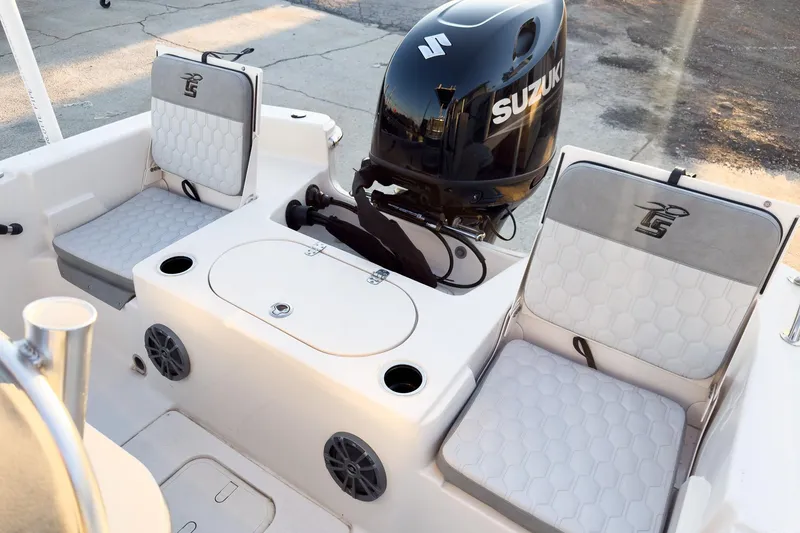 Slide: The Image of 2026 Carolina Skiff 19 LS boat interior with Suzuki engine and cushioned seating. - 23