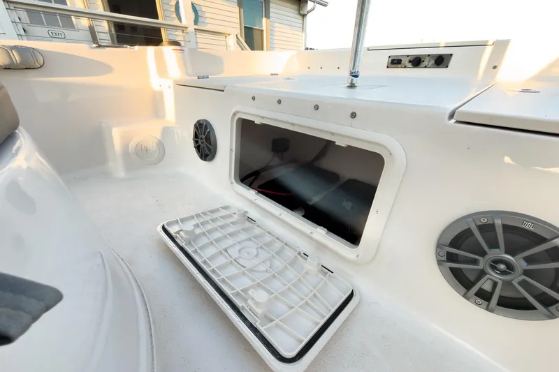 Slide: The Image of 2026 Carolina Skiff 19 LS boat interior with open storage compartment and speakers. - 32