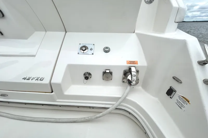 Slide: The Image of 2024 Regal 42 FXO boat deck with utility connections and control panel. - 14