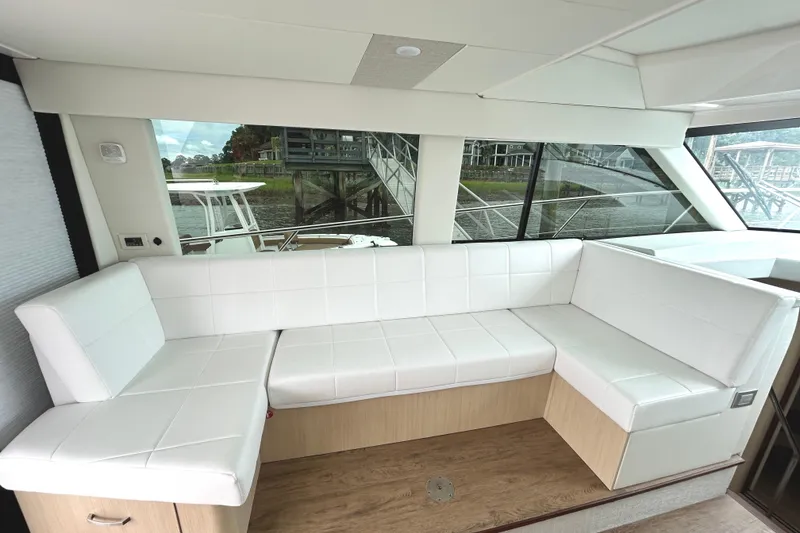 Slide: The Image of Luxurious interior of 2024 Regal 42 FXO yacht with white leather seating and large windows. - 18