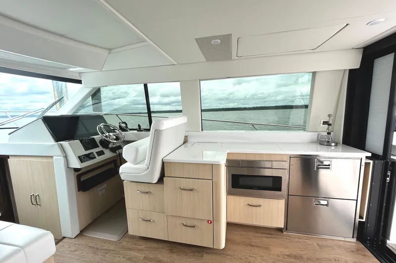 Slide: The Image of Luxurious interior of 2024 Regal 42 FXO yacht with modern helm and kitchenette. - 19