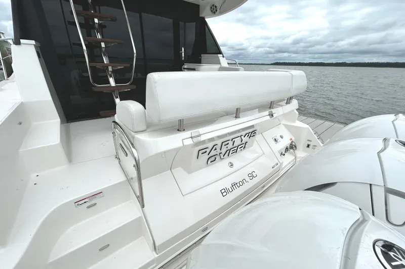 Slide: The Image of 2024 Regal 42 FXO yacht docked, featuring sleek design and luxurious seating, Bluffton, SC. - 2