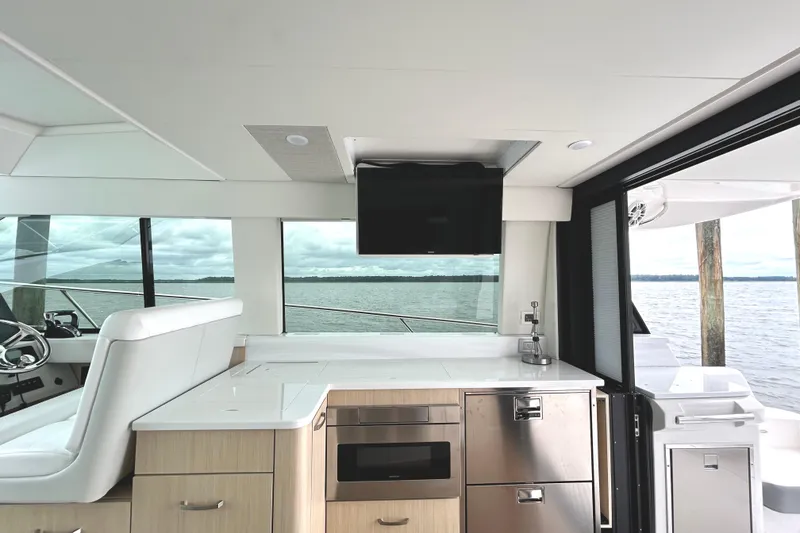 Slide: The Image of Interior of 2024 Regal 42 FXO yacht with modern kitchen and scenic water view. - 20