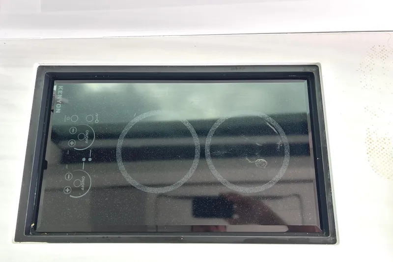 Slide: The Image of Kenyon electric cooktop on 2024 Regal 42 FXO yacht, featuring dual burners. - 25