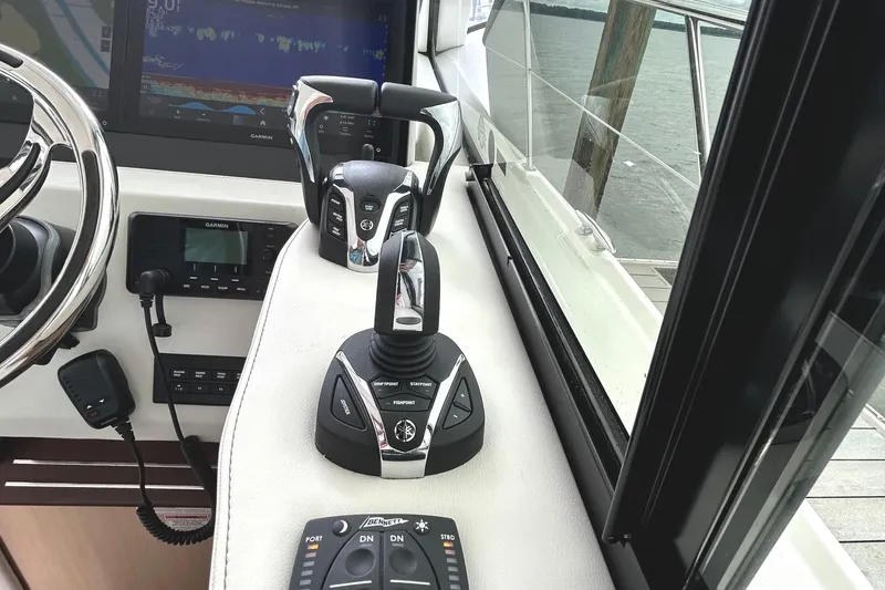 Slide: The Image of 2024 Regal 42 FXO helm with advanced controls and navigation displays. - 27