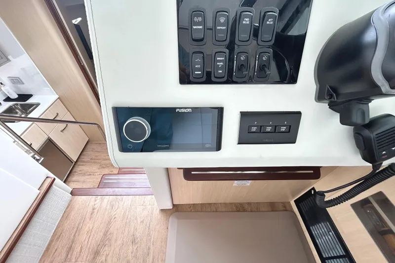 Slide: The Image of Control panel of 2024 Regal 42 FXO yacht with switches and Fusion audio system. - 31
