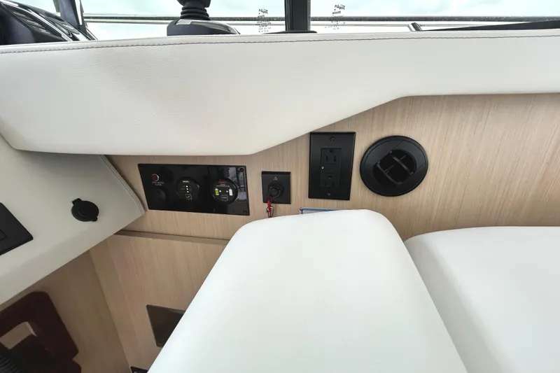 Slide: The Image of 2024 Regal 42 FXO yacht interior, featuring control panel and power outlets. - 32