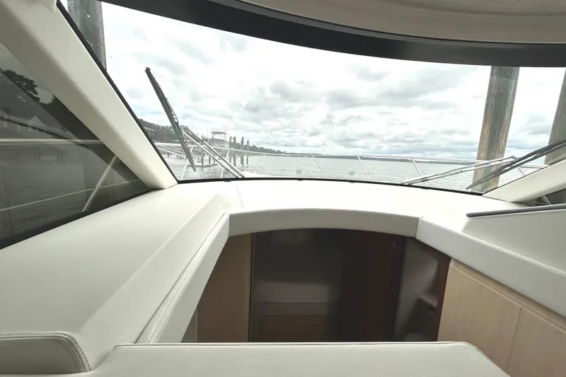 Slide: The Image of 2024 Regal 42 FXO yacht interior with panoramic water view through large windows. - 35