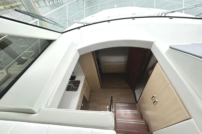 Slide: The Image of 2024 Regal 42 FXO yacht interior with stairs, kitchenette, and cabin view. - 36