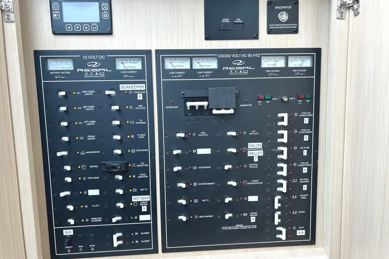Slide: The Image of Electrical control panel of 2024 Regal 42 FXO boat with various switches and meters. - 37