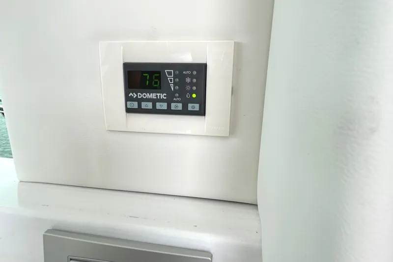 Slide: The Image of Dometic thermostat on 2024 Regal 42 FXO yacht, displaying 76 degrees. - 39