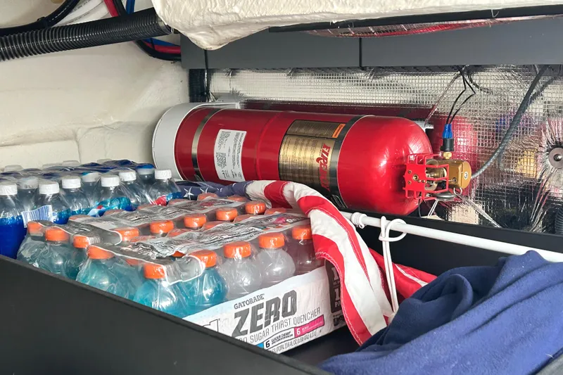 Slide: The Image of Storage area in 2024 Regal 42 FXO with fire extinguisher and beverages. - 52