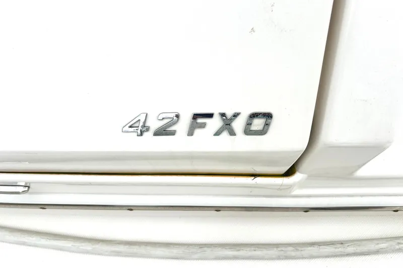 Slide: The Image of 2024 Regal 42 FXO boat model emblem on white surface. - 61