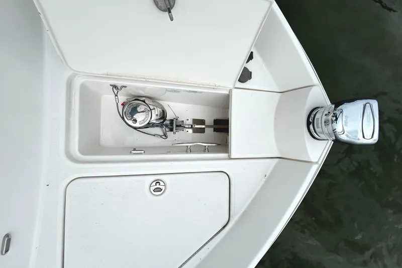 Slide: The Image of 2024 Regal 42 FXO boat anchor compartment with open hatch, showcasing anchor mechanism. - 7