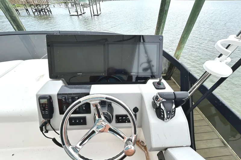 Slide: The Image of Helm of 2024 Regal 42 FXO boat with modern controls and dual displays. - 9