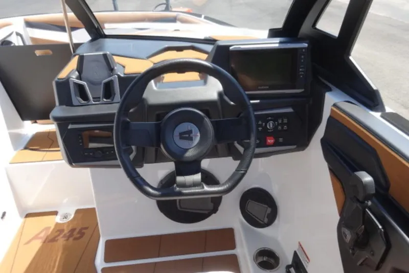 Slide: The Image of 2025 Axis A245 boat dashboard with steering wheel and control panel. - 10