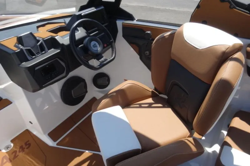Slide: The Image of 2025 Axis A245 boat interior with brown and white seating, modern dashboard, and steering wheel. - 5