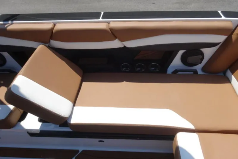 Slide: The Image of 2025 Axis A245 boat interior with brown and white cushioned seating. - 9