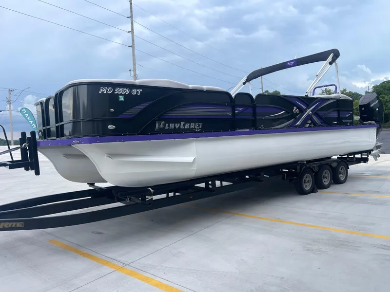 Slide: The Image of 2023 PlayCraft 3000 Infinity Extreme boat on trailer, parked in a lot under cloudy sky. - 10