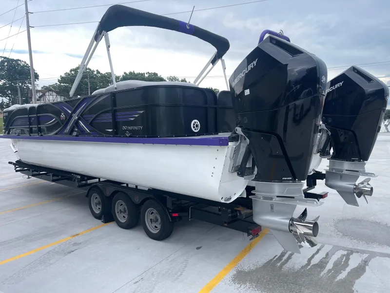 Slide: The Image of 2023 PlayCraft 3000 Infinity Extreme boat on trailer with powerful Mercury engines. - 12