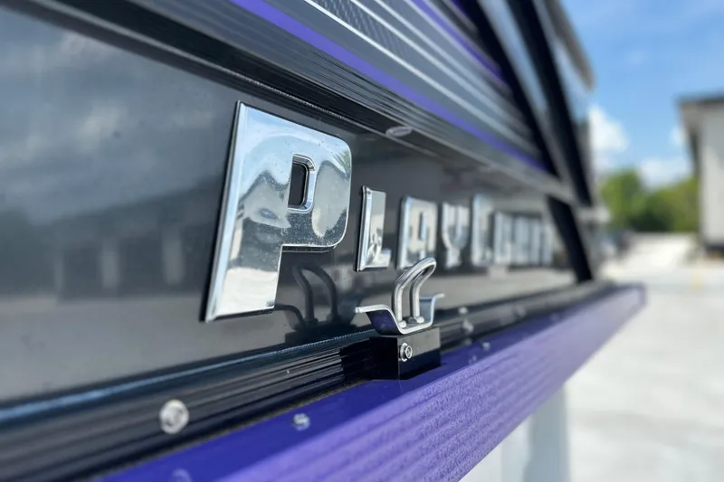 Slide: The Image of Close-up of 2023 PlayCraft 2800 Extreme boat logo with chrome finish. - 14