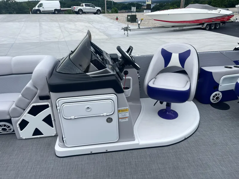 Slide: The Image of 2023 PlayCraft 3000 Infinity Extreme boat interior with steering console and cushioned seating. - 23