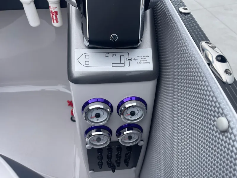 Slide: The Image of Control panel of 2023 PlayCraft 3000 Infinity Extreme boat with gauges and switches. - 31