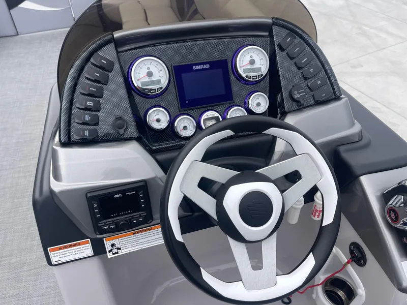 Slide: The Image of 2023 PlayCraft 3000 Infinity Extreme dashboard with steering wheel and control panel. - 35