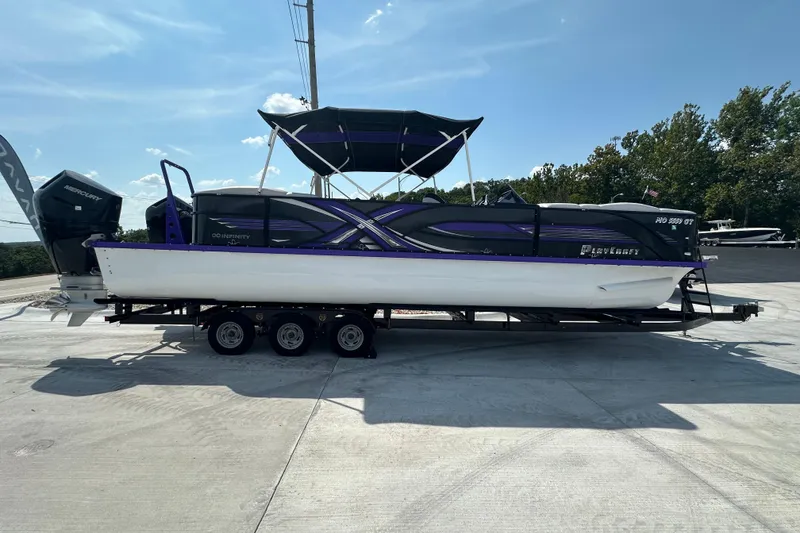 Slide: The Image of 2023 PlayCraft 2800 Extreme boat on trailer, featuring sleek design and powerful Mercury engine. - 6