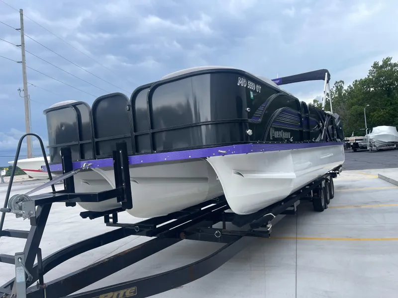 Slide: The Image of 2023 PlayCraft 3000 Infinity Extreme pontoon boat on trailer, parked outdoors. - 7